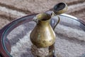 An old small copper jug with a lid. Royalty Free Stock Photo