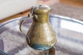 An old small copper jug with a lid. Royalty Free Stock Photo