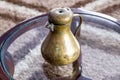 An old small copper jug with a lid. Royalty Free Stock Photo