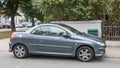 Old small French car Peugeot convertible parked right side view