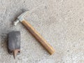 Old small hammer and miniature anvil with concrete background Royalty Free Stock Photo