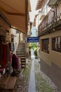 Old small Italian street with a restaurant and shop.