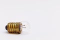 An old small light bulb on white background Royalty Free Stock Photo