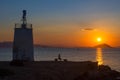 Old small lighthouse of the Aegina island, Saronic gulf, Greece, at sunset