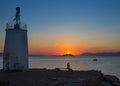 Old small lighthouse of the Aegina island, Saronic gulf, Greece, at sunset