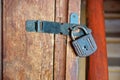 Old small lock hanging on the pantry door