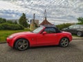 Old small red coupe car Mazda MX-5 parked