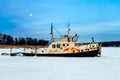 Old small and rusty tugboat at pier