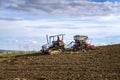 An old small tractor cultivated ground and sows. Agriculture and agronomy concept