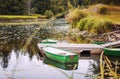 An old small wooden boat on the lake near the shore, a beautiful Royalty Free Stock Photo