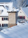 Smoking chimney covered with snow and icicled Royalty Free Stock Photo