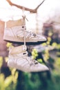 Old sneakers hanging on laces in the spring garden Royalty Free Stock Photo