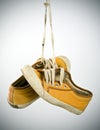 Old sneakers hanging Royalty Free Stock Photo