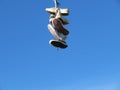 old sneakers hanging on a wire meaning trash