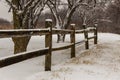 old snowy fence in the park in the morning Royalty Free Stock Photo