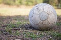 Old soccer ball on grass field Royalty Free Stock Photo