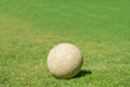 Old soccer ball on green grass of soccer field Royalty Free Stock Photo