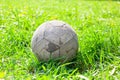 Old soccer ball on the green grass Royalty Free Stock Photo