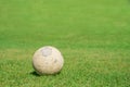 Old soccer ball on green grass of soccer field Royalty Free Stock Photo