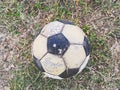 Old soccer ball on the ground Royalty Free Stock Photo