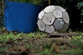 Old soccer ball lay on grass. Close up of worn out football. Royalty Free Stock Photo