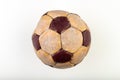 Old soccer ball to play on the leg on a white table. Leather and destroyed ball without air Royalty Free Stock Photo