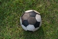 old soccer or football ball on green grass by top view Royalty Free Stock Photo