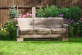 Old sofa brown placed on bricks in green garden Royalty Free Stock Photo