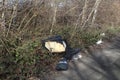 An old sofa ,couch fly tipped in a country lane with an environmental impact the wild life Royalty Free Stock Photo