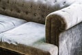 Old sofa. A piece of upholstered furniture with a round armrest in gray fabric. Close-up Royalty Free Stock Photo