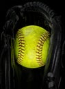 Old softball in a glove Royalty Free Stock Photo