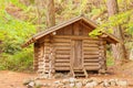 Old solid log cabin shelter hidden in the forest Royalty Free Stock Photo