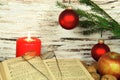 Old songbook, christmas decoration and candle
