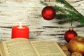 Old songbook, christmas decoration and candle