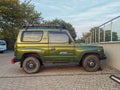 Old small classic vintage green offroad 4WD car Kia parked
