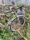 An old Soviet bicycle surrounded by junk.