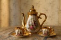 Old soviet gilded porcelain teapot and two cups.