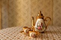 Old soviet gilded porcelain teapot and two cups. Royalty Free Stock Photo