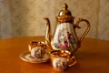 Old soviet gilded porcelain teapot and two cups. Royalty Free Stock Photo