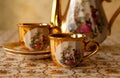 Old soviet gilded porcelain teapot and two cups. Royalty Free Stock Photo