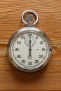 Old soviet mechanical stopwatch on the background of a wooden tabletop