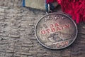 The Old Soviet Medal For Bravery of the Second World War with a red carnation, Victory Day May 9 postcard concept Royalty Free Stock Photo