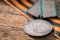 The Old Soviet Medal For Bravery of the Second World War with a red carnation, Victory Day May 9 postcard concept