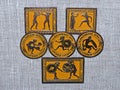 Old Soviet metal badges with the image of the an ancient athletes and the inscription `Olympic Games of Ancient Greece`. Closeup.