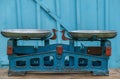 Old Soviet scales with aluminum bowls against the background of a light blue wooden textured wall Royalty Free Stock Photo