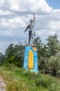 The old Soviet sculpture Worker and Collective Farm on road offers entry into a dying Ukrainian village. Old Soviet monument,