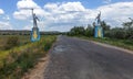 The old Soviet sculpture Worker and Collective Farm on road offers entry into a dying Ukrainian village. Old Soviet monument,