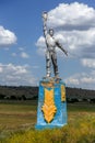 The old Soviet sculpture Worker and Collective Farm on road offers entry into a dying Ukrainian village. Old Soviet monument,