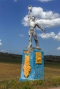 The old Soviet sculpture Worker and Collective Farm on road offers entry into a dying Ukrainian village. Old Soviet monument,