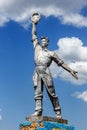 The old Soviet sculpture Worker and Collective Farm on road offers entry into a dying Ukrainian village. Old Soviet monument,